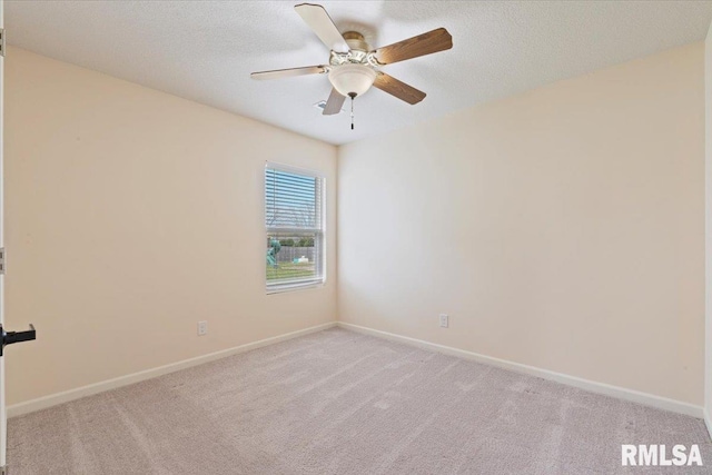 spare room with baseboards, ceiling fan, a textured ceiling, and light colored carpet