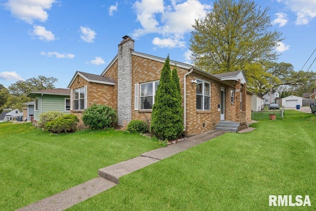 view of side of property featuring a yard, brick siding, and a chimney