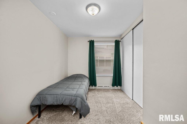 bedroom with carpet flooring and baseboard heating