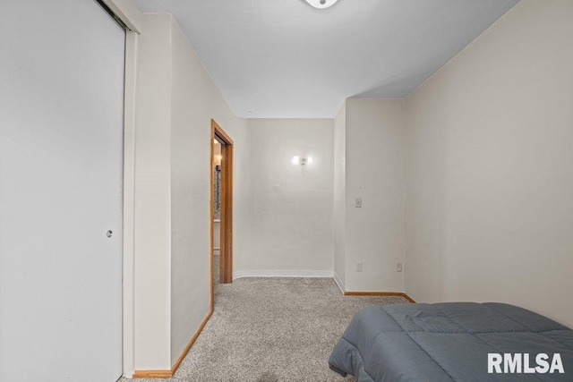 bedroom with carpet floors and baseboards
