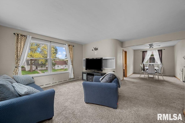 living area featuring a baseboard radiator, carpet flooring, and a wealth of natural light
