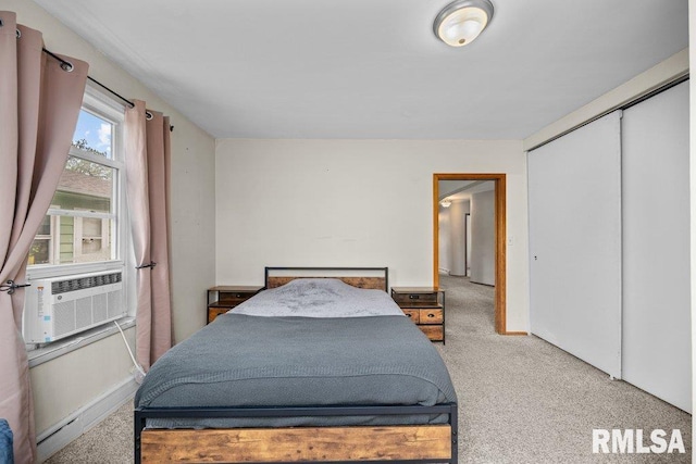 bedroom featuring carpet floors, cooling unit, and a closet