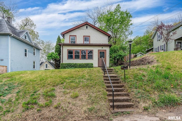 back of property with a lawn