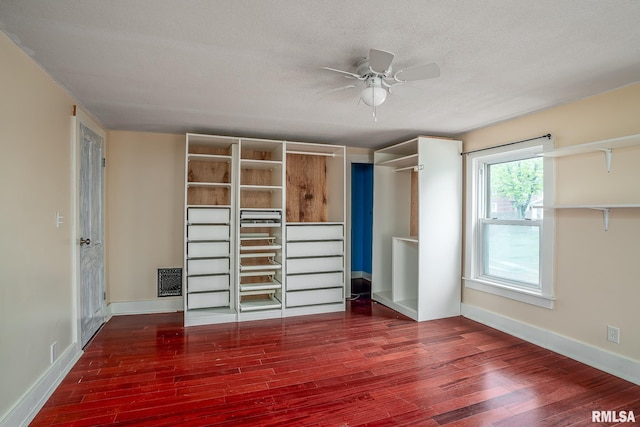 unfurnished bedroom featuring a textured ceiling, baseboards, and wood finished floors
