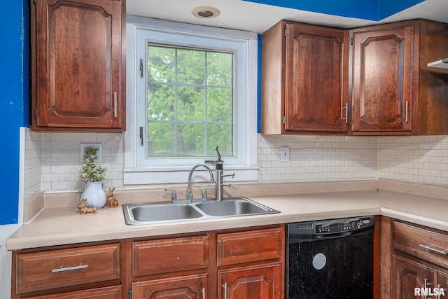 kitchen featuring black dishwasher, tasteful backsplash, a sink, and light countertops