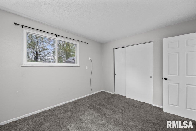 unfurnished bedroom with a closet, baseboards, and carpet flooring