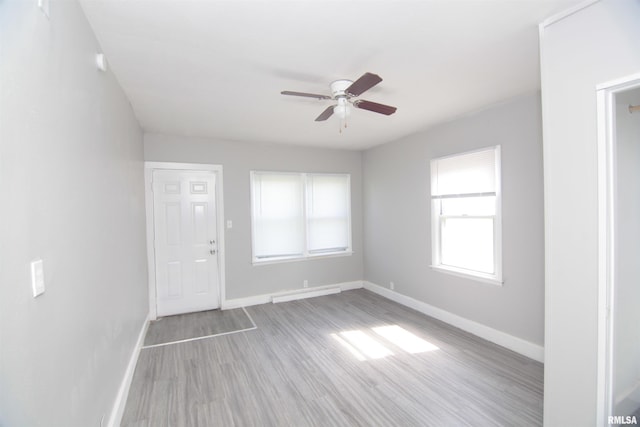 foyer entrance featuring baseboards, a ceiling fan, and wood finished floors