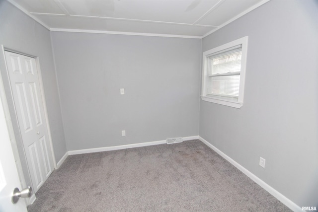 carpeted spare room with baseboards and visible vents