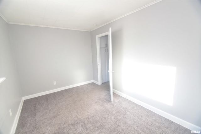 unfurnished bedroom with baseboards, ornamental molding, and carpet