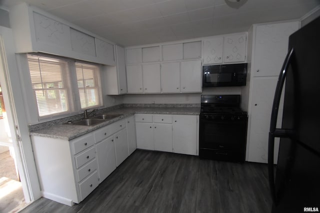kitchen featuring dark wood-type flooring, a sink, white cabinets, and black appliances