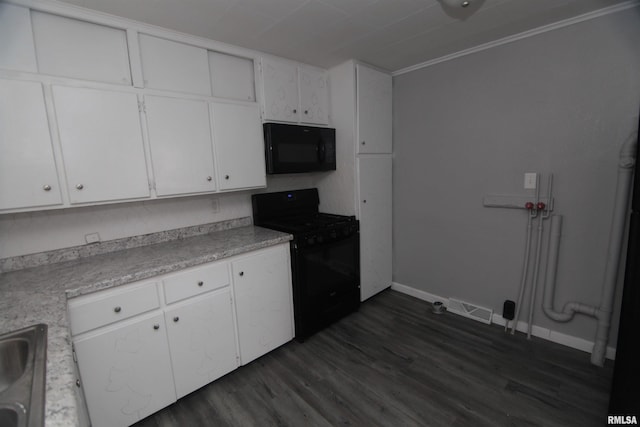 kitchen with white cabinets, dark wood-style flooring, baseboards, visible vents, and black appliances