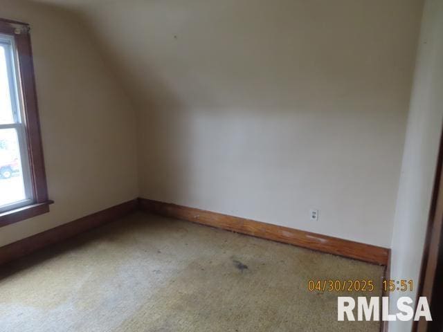 bonus room featuring carpet floors, plenty of natural light, baseboards, and lofted ceiling