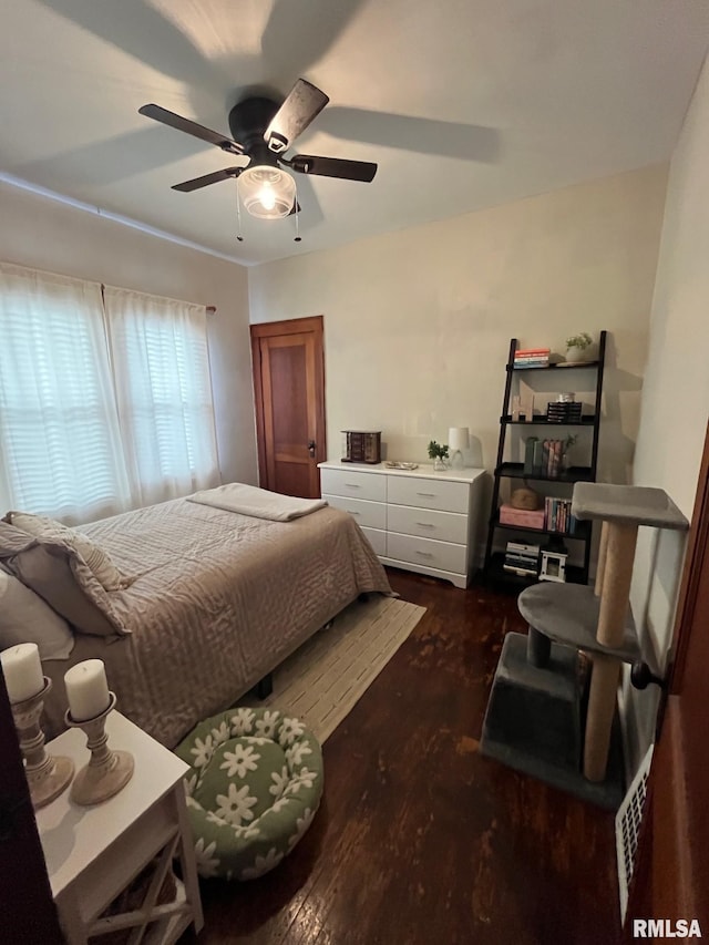 bedroom with ceiling fan and dark wood finished floors