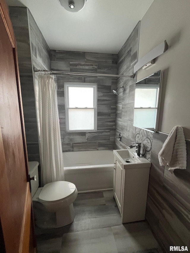 bathroom featuring vanity, toilet, tile walls, and shower / tub combo with curtain