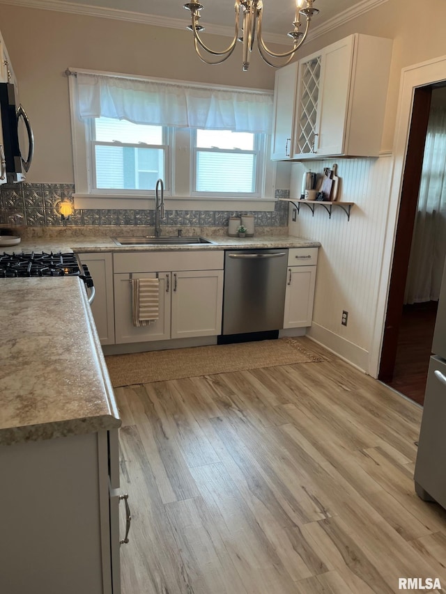 kitchen with ornamental molding, black microwave, a sink, dishwasher, and a notable chandelier