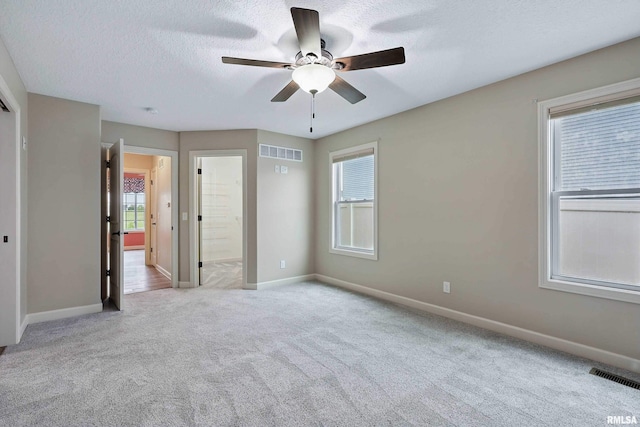 unfurnished bedroom featuring visible vents, carpet flooring, and baseboards