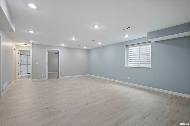 below grade area with visible vents, recessed lighting, baseboards, and light wood-type flooring