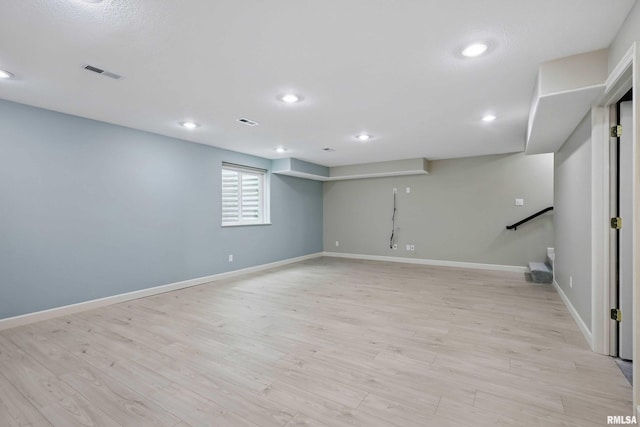 below grade area featuring visible vents, recessed lighting, light wood finished floors, and baseboards
