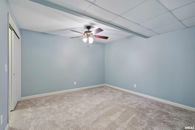 unfurnished bedroom featuring carpet floors, baseboards, a ceiling fan, and a closet