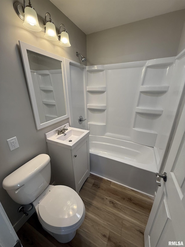 full bathroom featuring vanity, wood finished floors, toilet, and shower / washtub combination