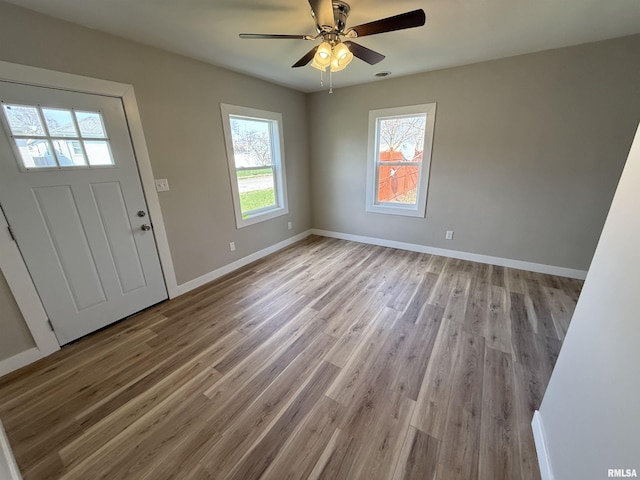 entrance foyer featuring baseboards, a ceiling fan, and wood finished floors