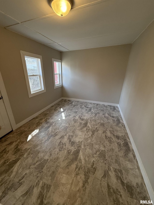 unfurnished room featuring baseboards