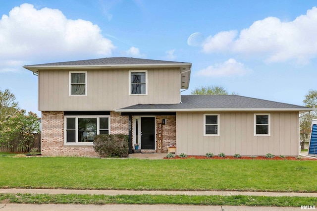 view of front of property with brick siding and a front yard
