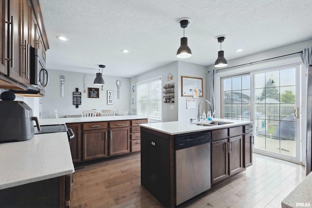 kitchen with recessed lighting, a sink, appliances with stainless steel finishes, and wood finished floors