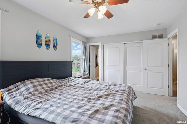 bedroom featuring a closet, carpet, ceiling fan, and visible vents