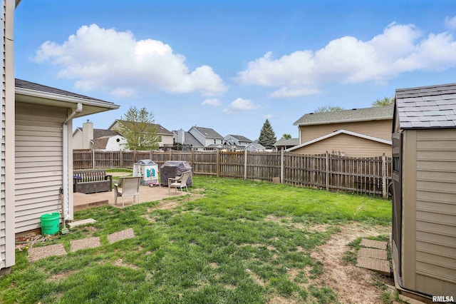 view of yard featuring a fenced backyard, a patio, and a residential view