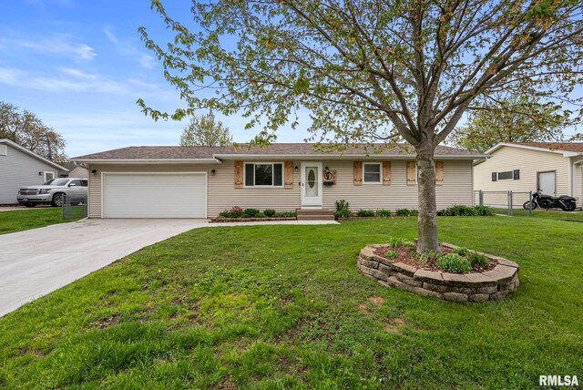ranch-style home featuring fence, an attached garage, driveway, and a front yard