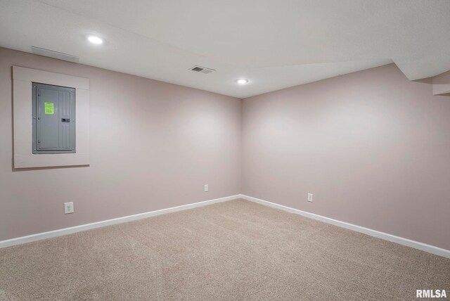 carpeted empty room with recessed lighting, baseboards, electric panel, and visible vents