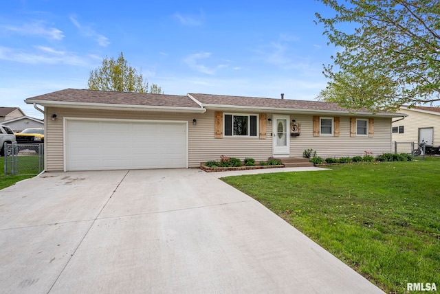 ranch-style house featuring fence, a garage, driveway, and a front lawn
