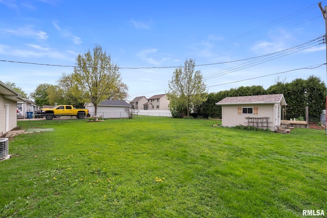 view of yard featuring fence and an outdoor structure
