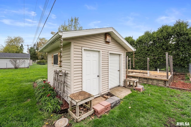 view of outbuilding with an outdoor structure and fence