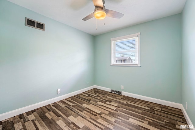 unfurnished room featuring visible vents, a ceiling fan, baseboards, and dark wood-style floors