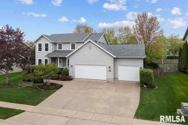 traditional-style home with a garage, fence, a front yard, roof with shingles, and driveway