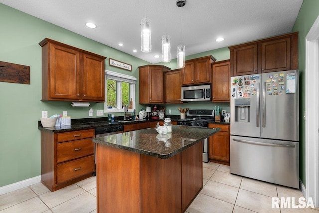 kitchen featuring pendant lighting, a center island, a sink, light tile patterned floors, and stainless steel appliances