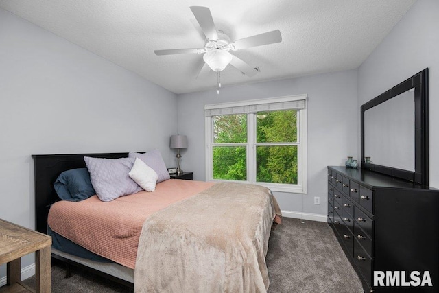 bedroom featuring baseboards, ceiling fan, dark colored carpet, and a textured ceiling