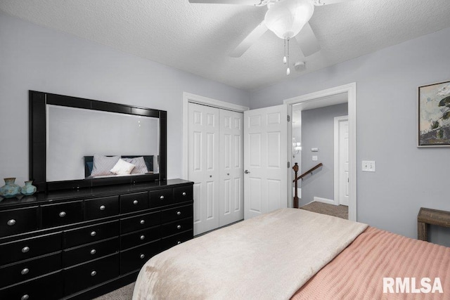 bedroom with a ceiling fan, a closet, carpet flooring, and a textured ceiling
