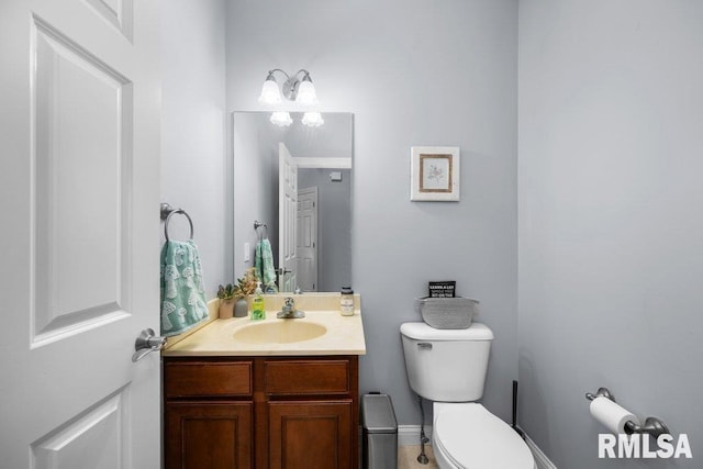 bathroom featuring toilet and vanity