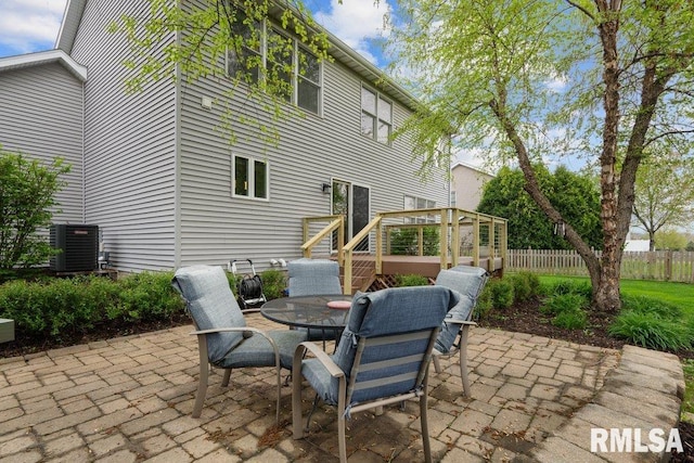 view of patio / terrace featuring fence, central AC unit, and outdoor dining area