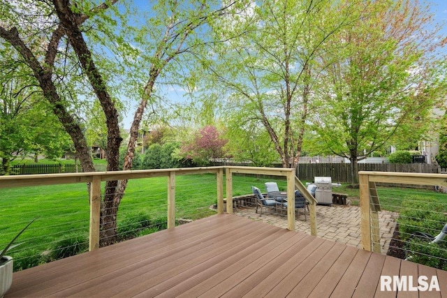 wooden terrace with a fenced backyard, a patio area, and a yard