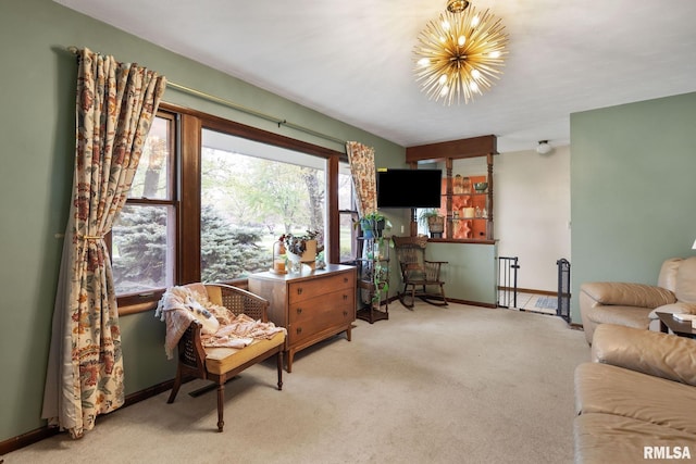 living area with baseboards, light colored carpet, and an inviting chandelier