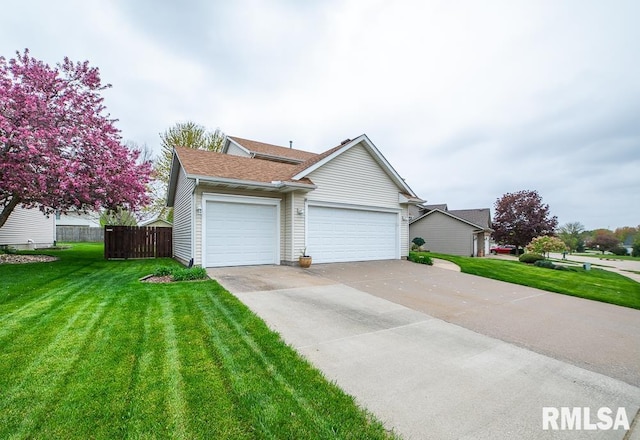 view of front of home with roof with shingles, a front yard, fence, concrete driveway, and an attached garage