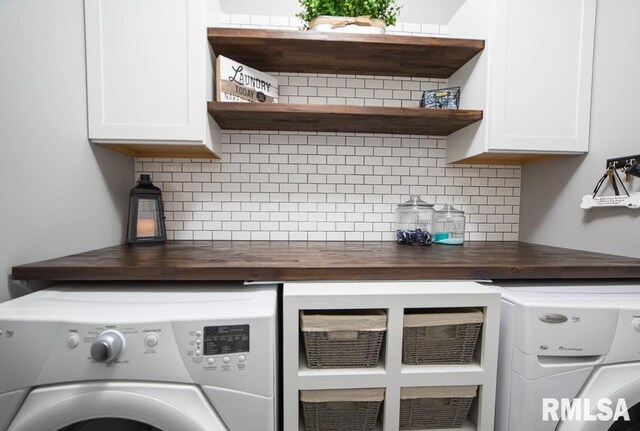 laundry room with independent washer and dryer and cabinet space