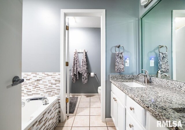 full bath with toilet, tile patterned floors, a bath, and vanity