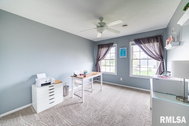 office featuring baseboards, visible vents, ceiling fan, and carpet