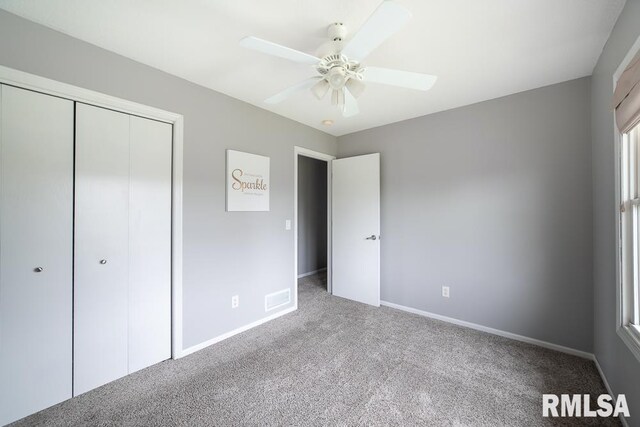 unfurnished bedroom featuring carpet floors, baseboards, a closet, and ceiling fan