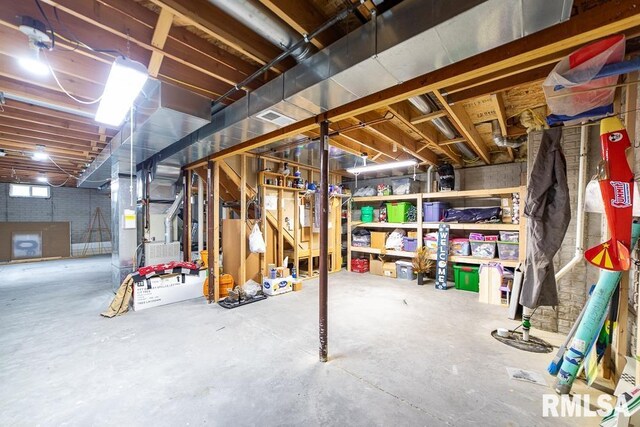 basement featuring heating unit and visible vents